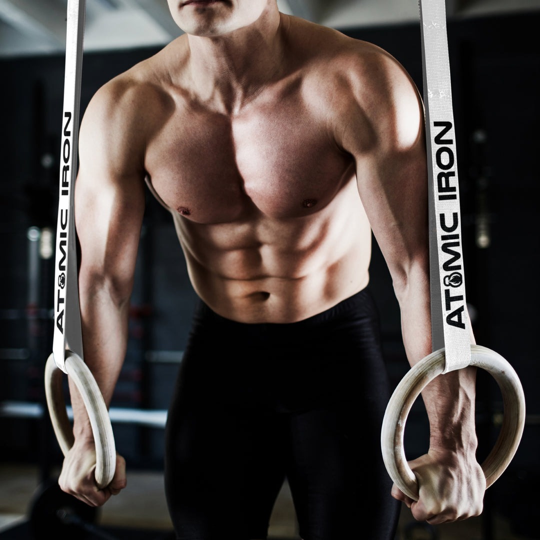 Strong man working out with Atomic Iron gymnastic rings