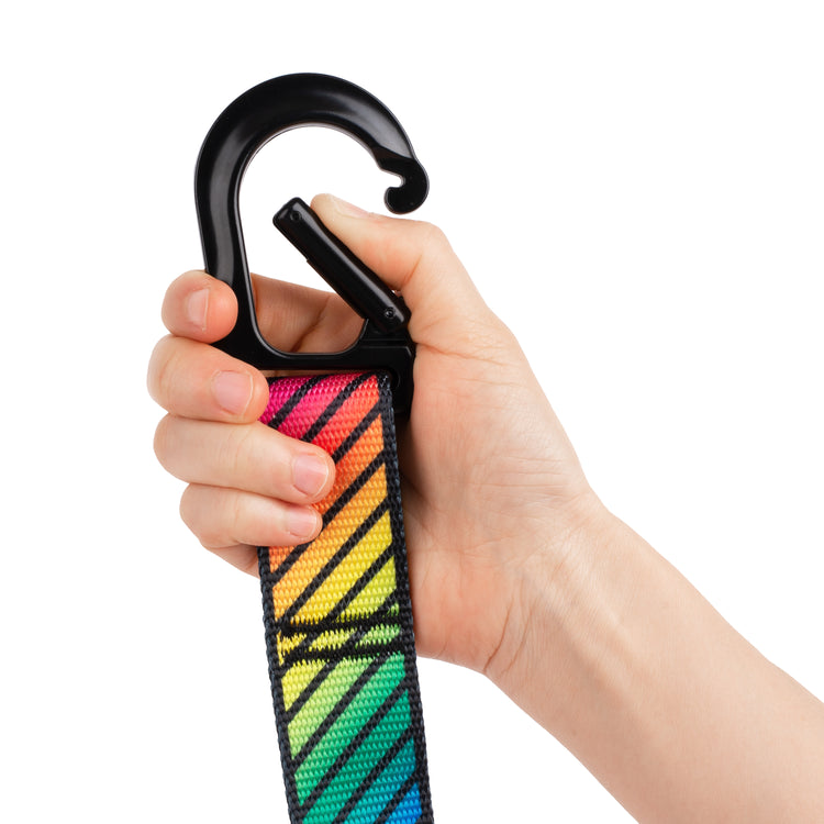 Close up on rainbow gymnastic rings strap with hand opening carabiner