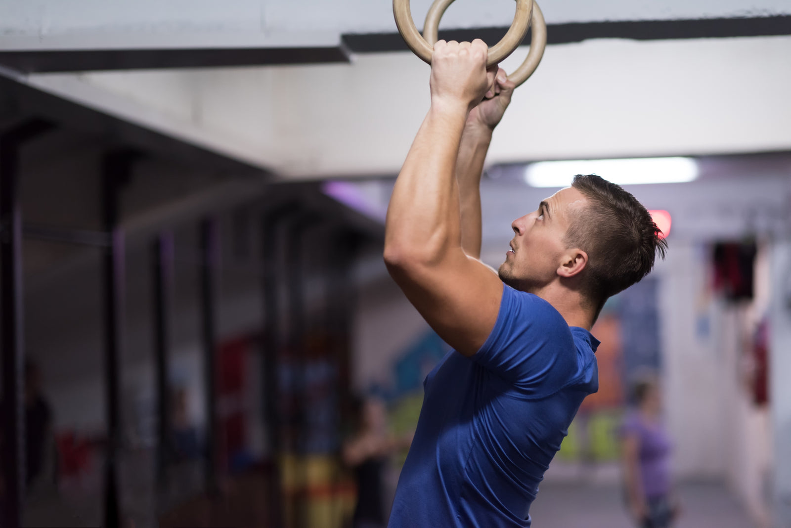 Man doing pull ups on Atomic Iron gymnastic rings