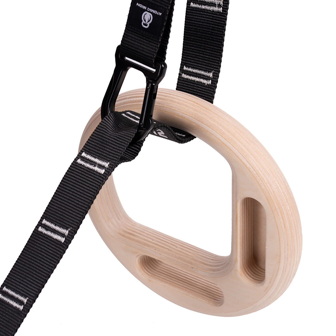 Gymnastic rings with hangboard edges and carabiner straps by Atomic Iron